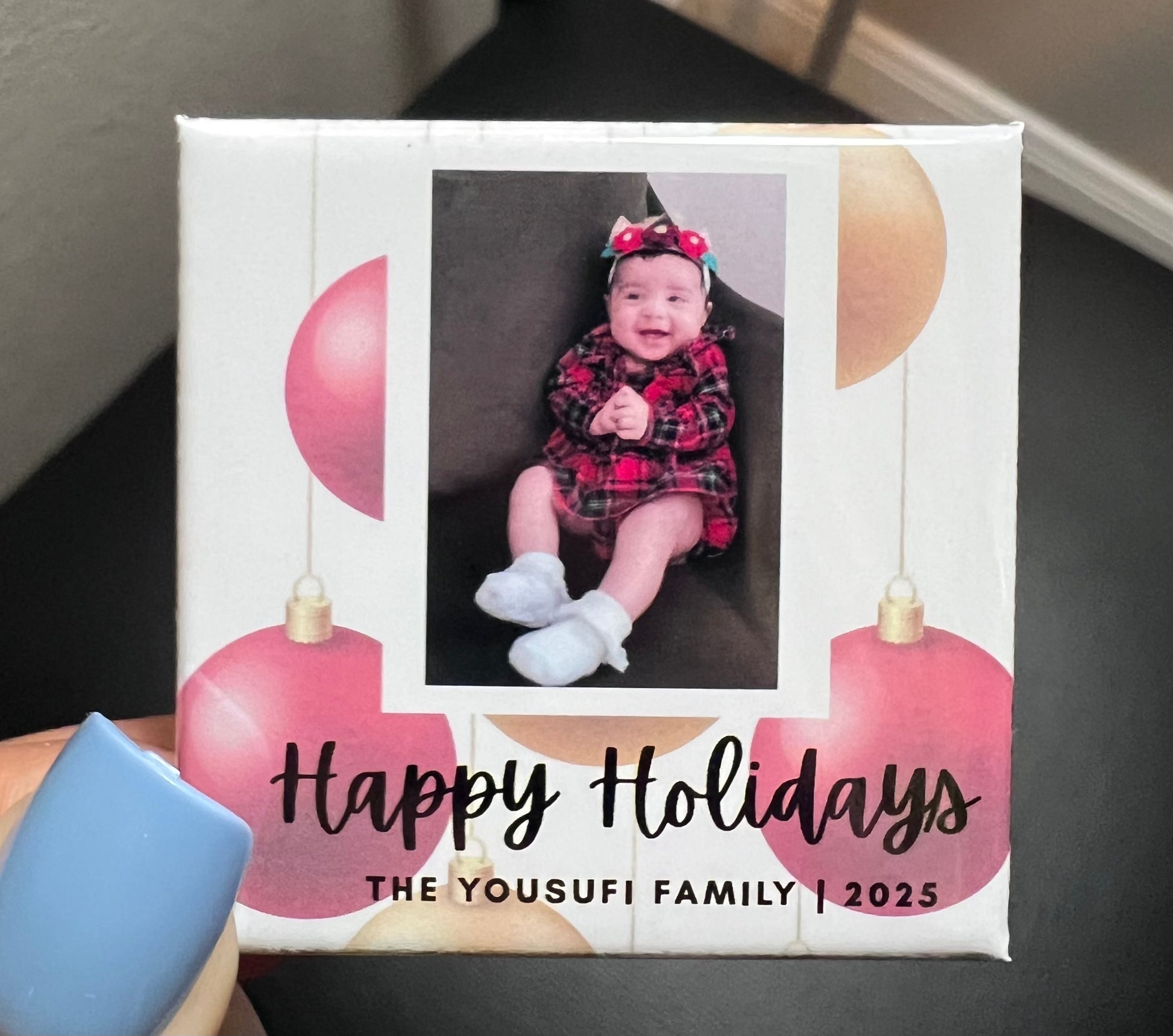 Holiday photo magnet with a photo of a baby and 'Happy Holidays' text