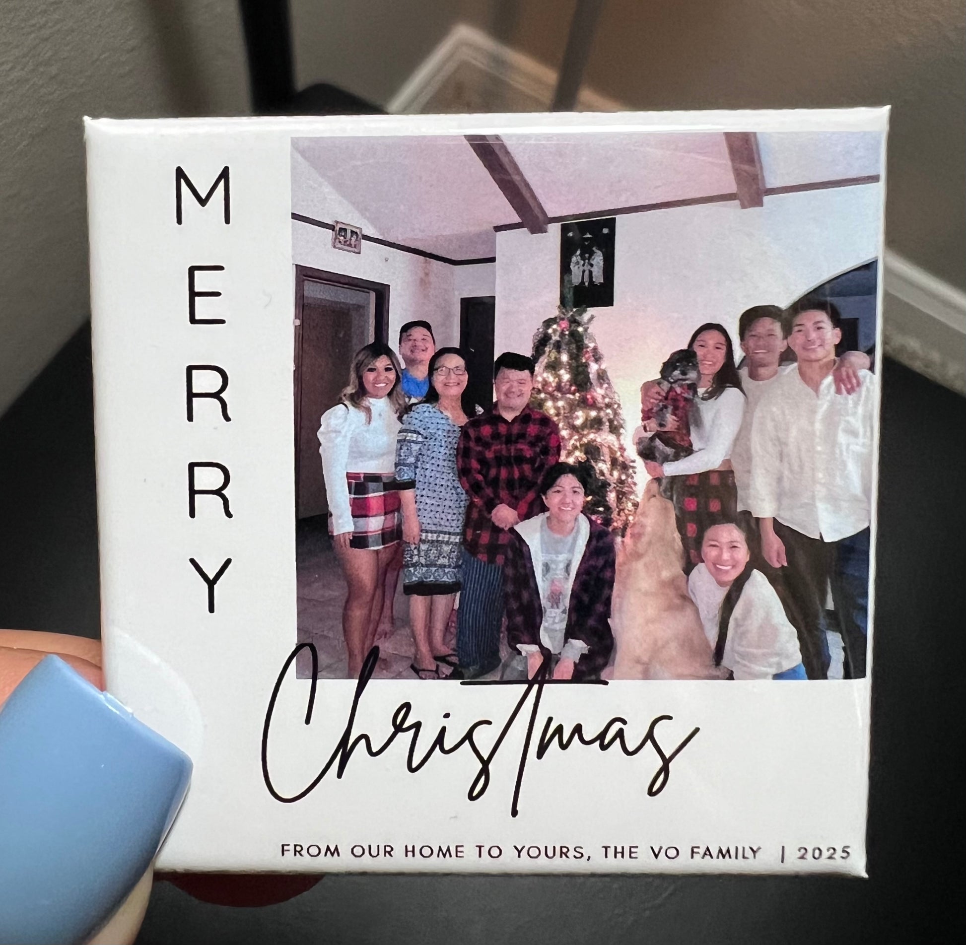 Personalized Christmas photo magnet with a family photo and 'Merry Christmas' text.