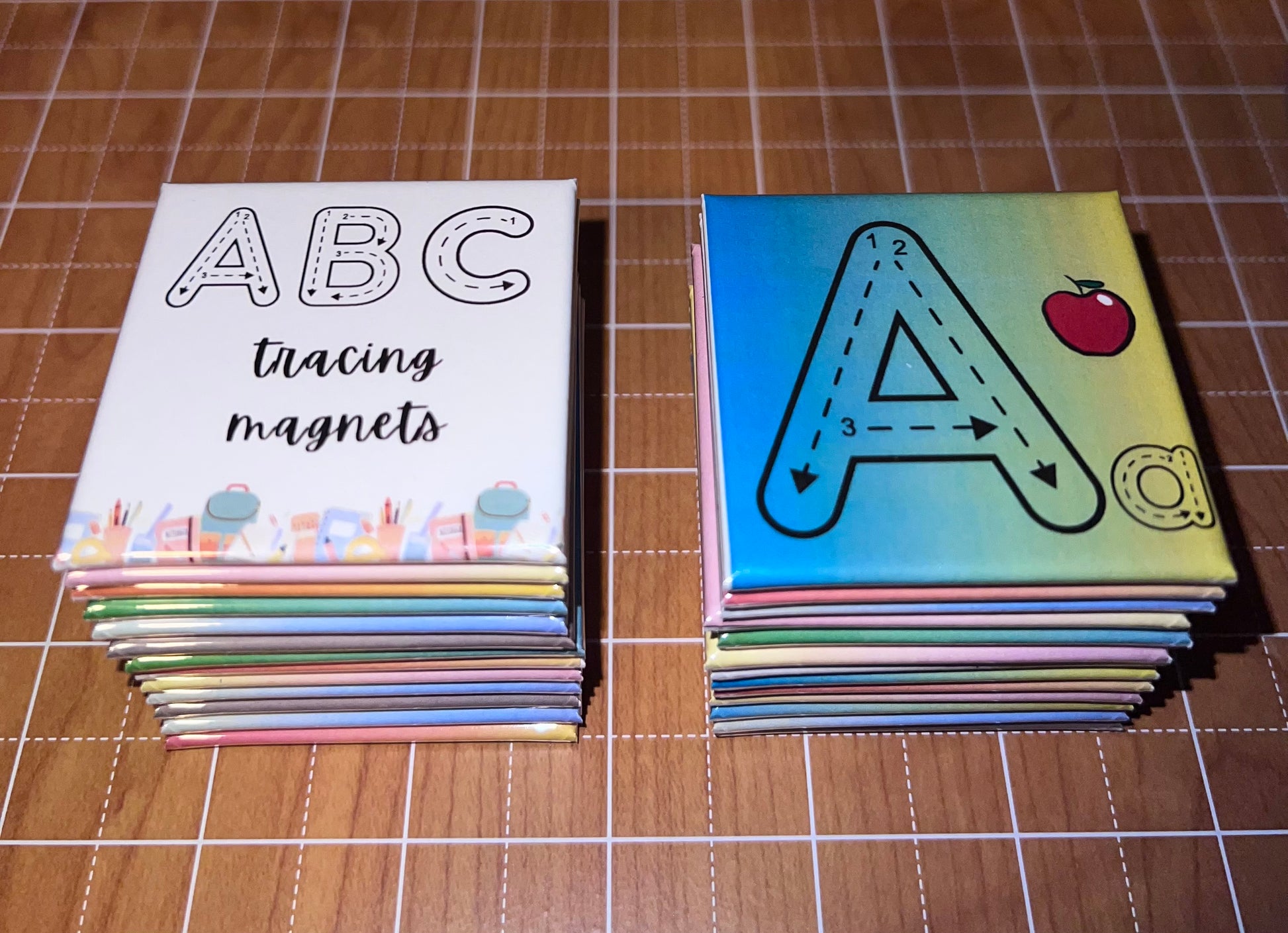 Stacks of ABC tracing magnets on a grid background