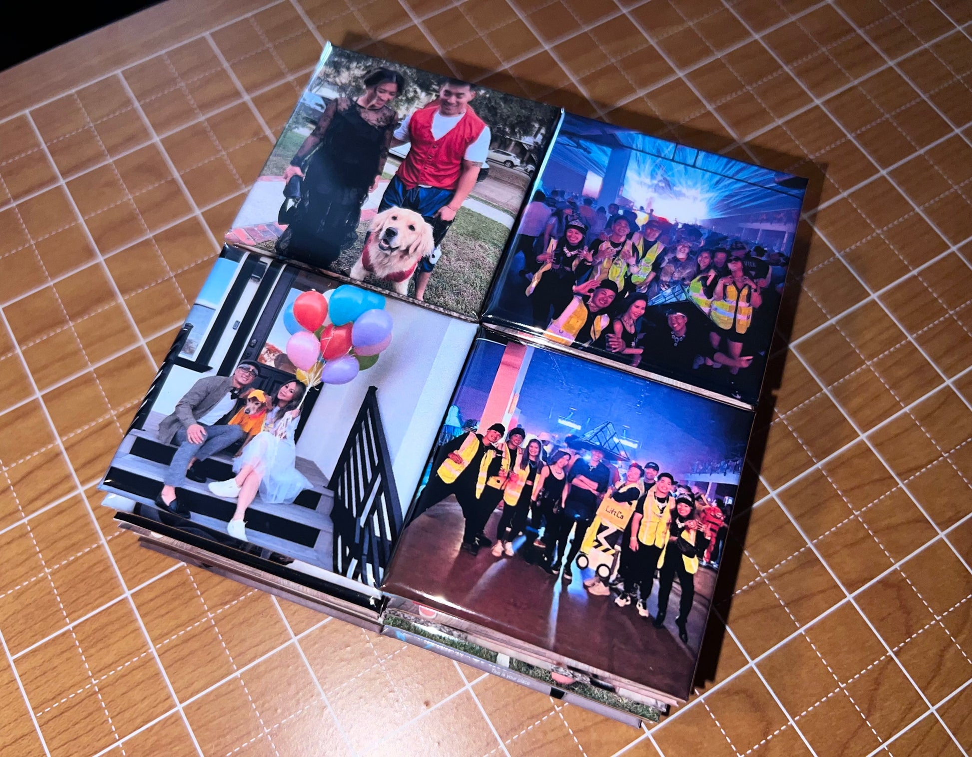 Stack of photo albums with various images on a tiled background